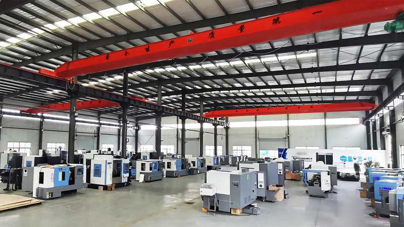 Dozens of modern machine tools are neatly aligned in a production workshop, with consistent spacing between equipment and clear floor markings, presenting a highly standardized manufacturing environment.