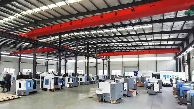 Dozens of modern machine tools are neatly aligned in a production workshop, with consistent spacing between equipment and clear floor markings, presenting a highly standardized manufacturing environment.